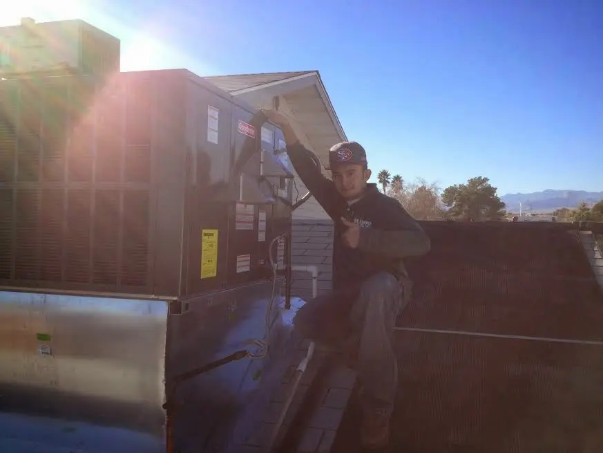 HVAC technician performing HVAC Inspection on a rooftop unit in Cameron Park